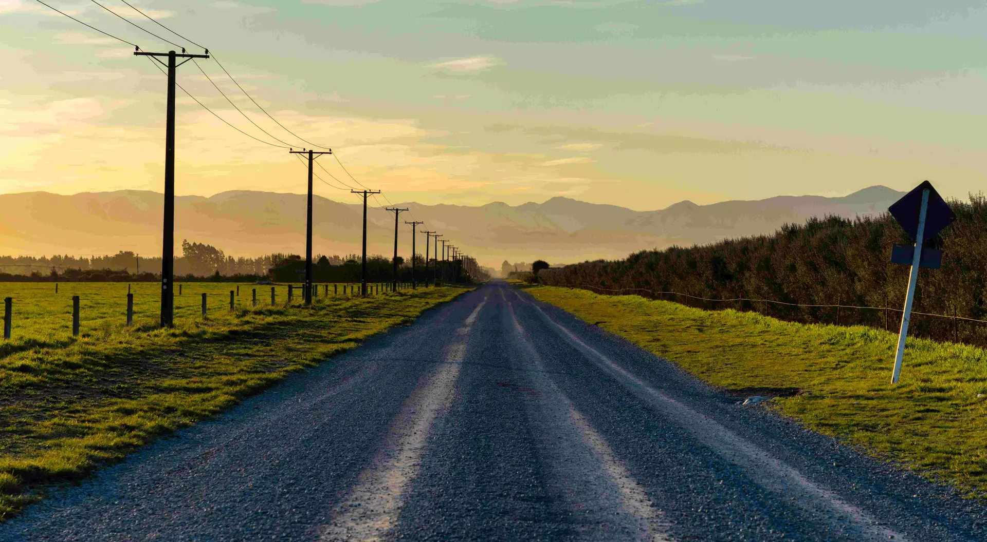 Sunset draws closer on a road running towards the Southern Alps, on New Zealand's South Island