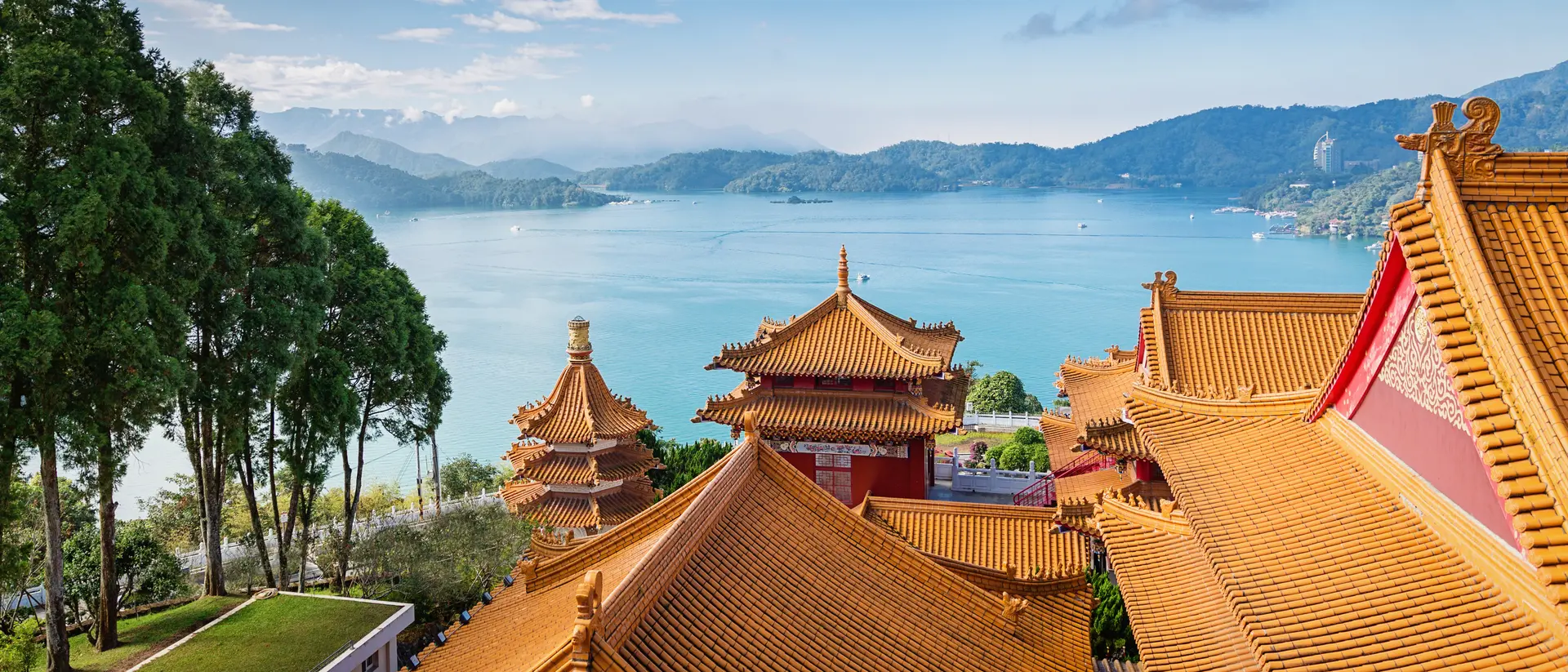 Beautiful view towards the famous Sun Moon Lake View under blue sunny sky over Wen Wu Temple Rooftops.