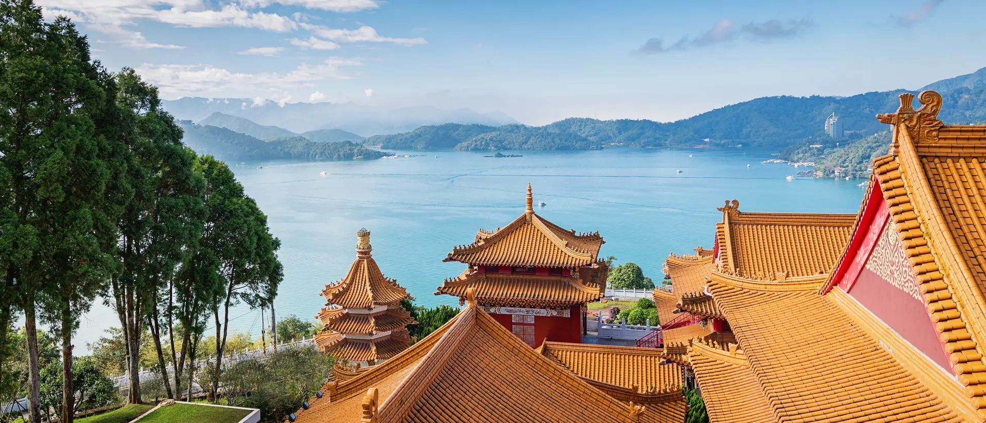 Beautiful view towards the famous Sun Moon Lake View under blue sunny sky over Wen Wu Temple Rooftops.
