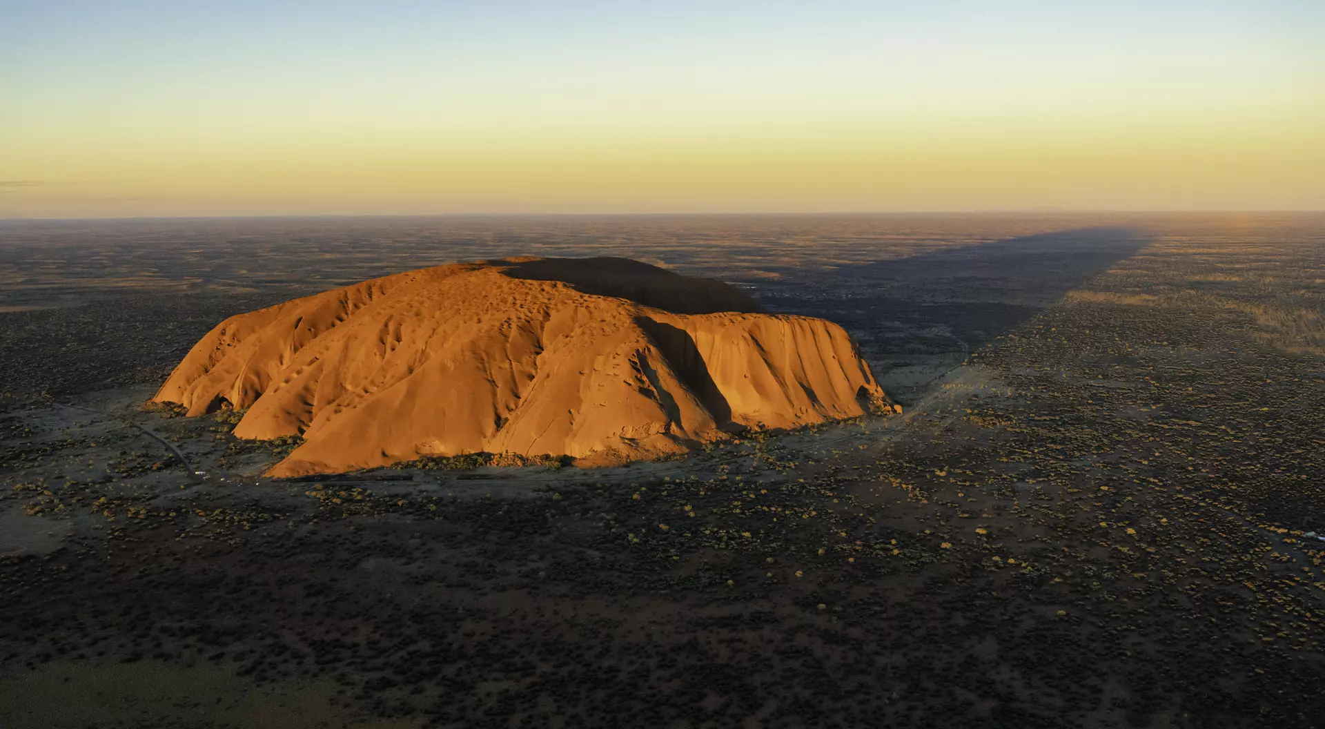Evening sun shines down on the magnificence of Uluru