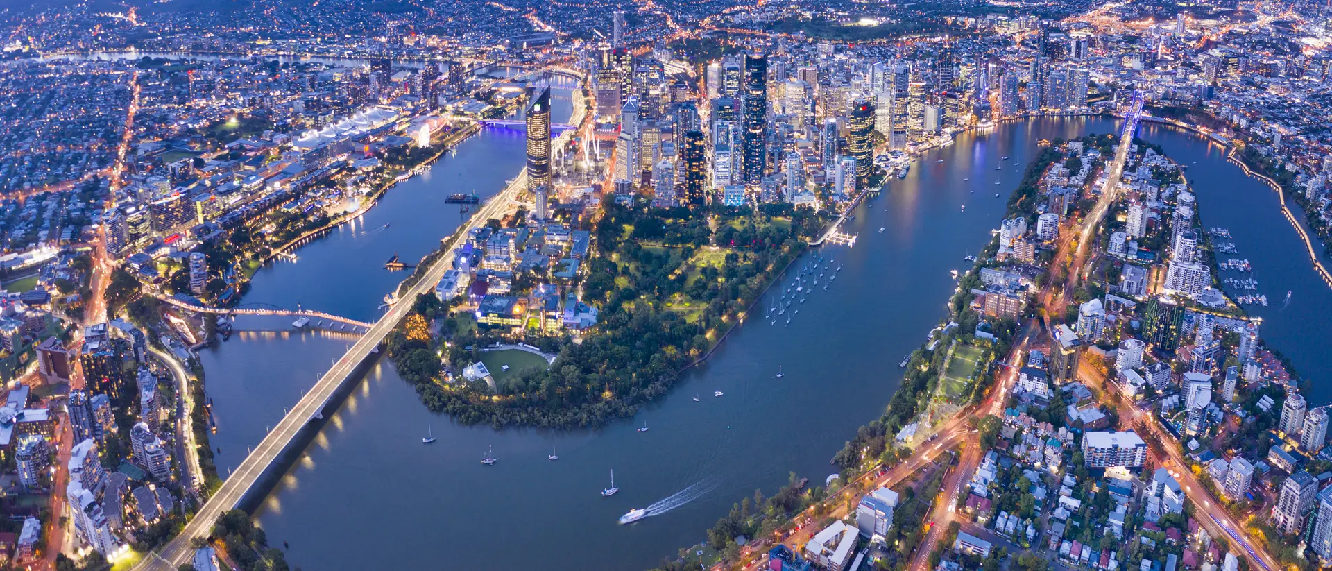 Brisbane Skyline Night Panorama with the famous illuminated Story Bridge, Botanical Garden and Whell, Queensland, Australia.