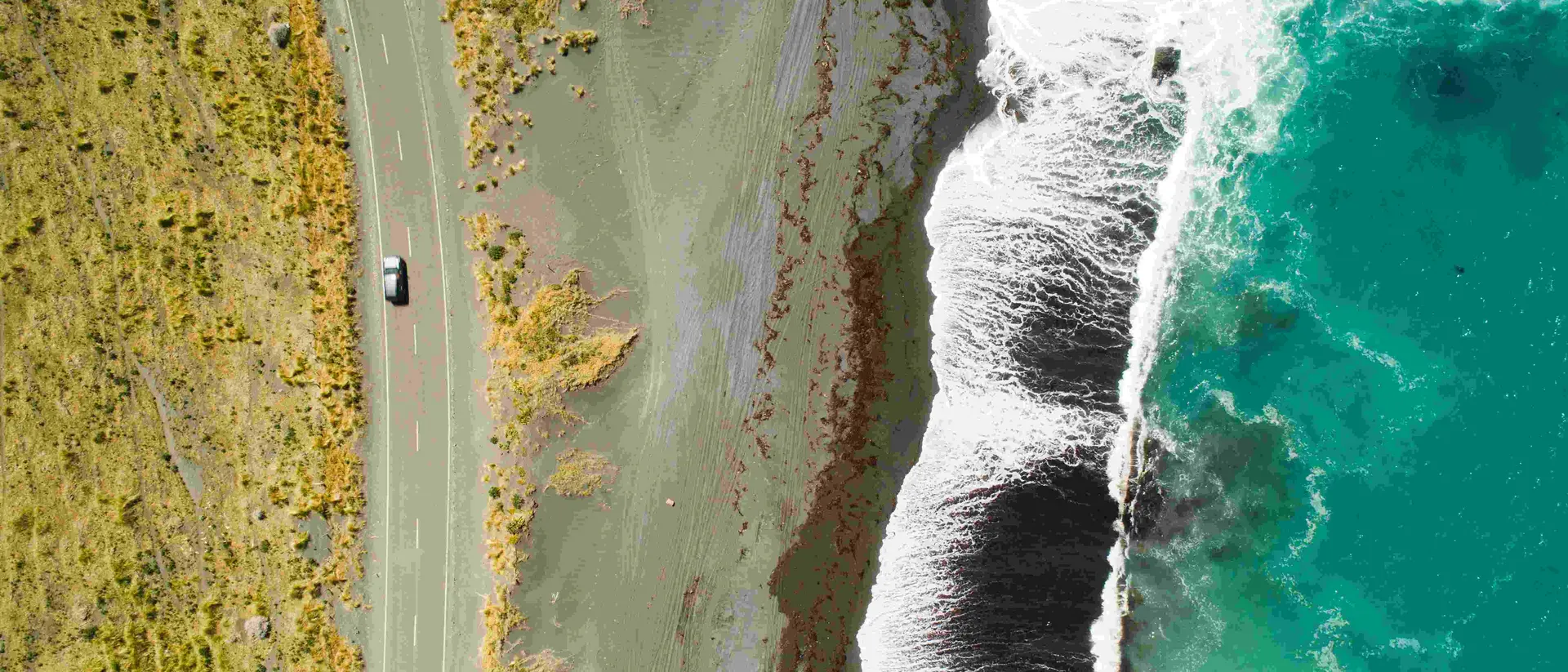 Top view of sea, waves and road in Wairarapa Region