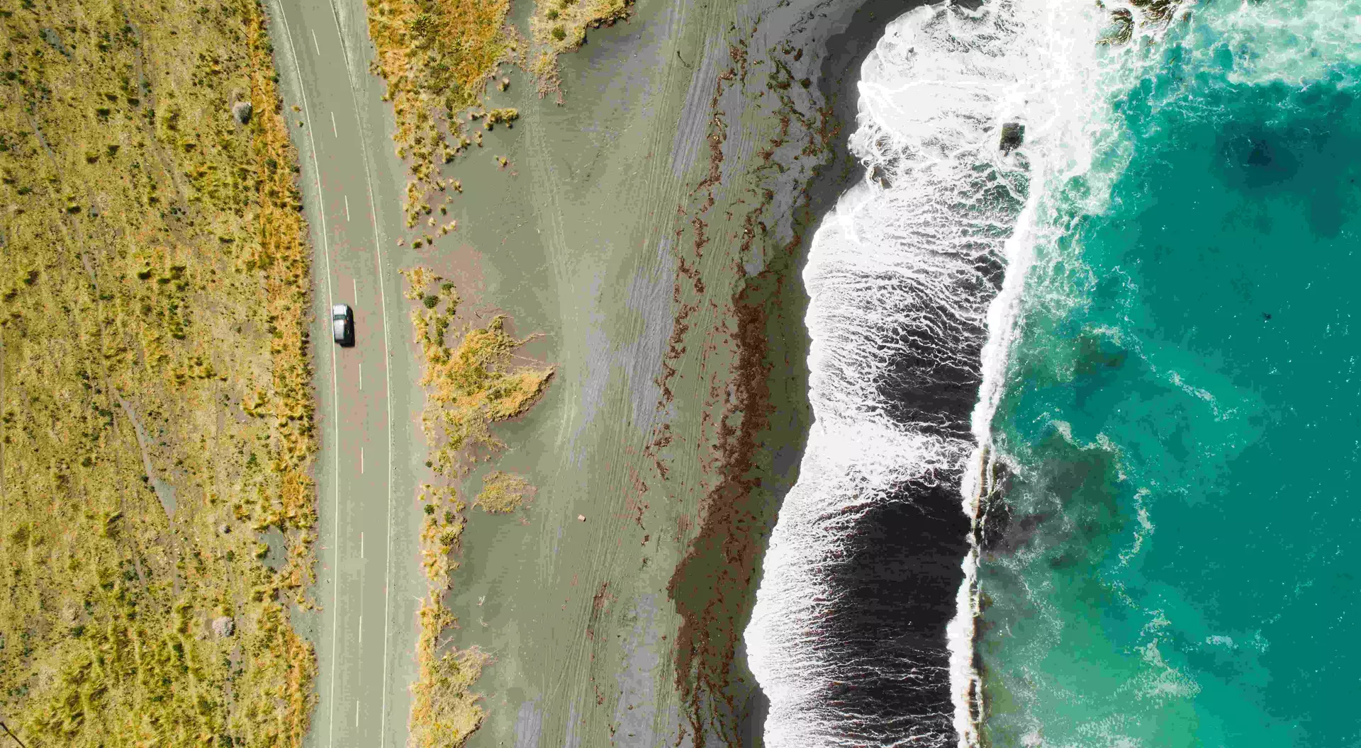 Top view of sea, waves and road in Wairarapa Region