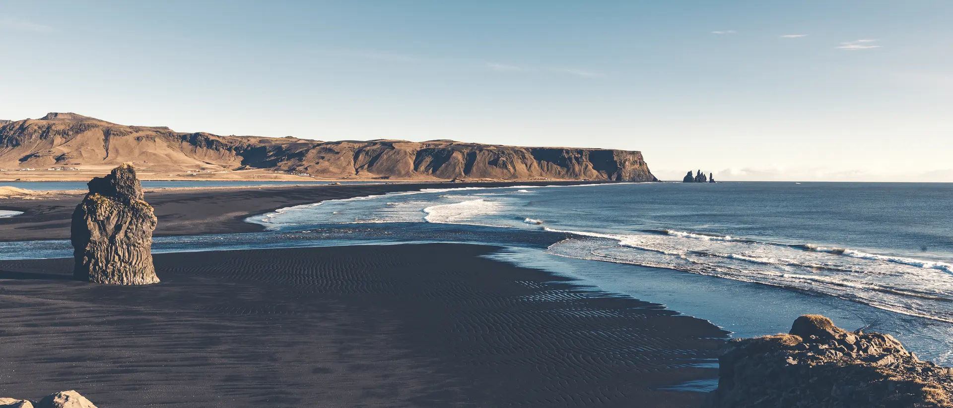 Cape Dyrholaey, Arnardrangur Rock on black sand beach.