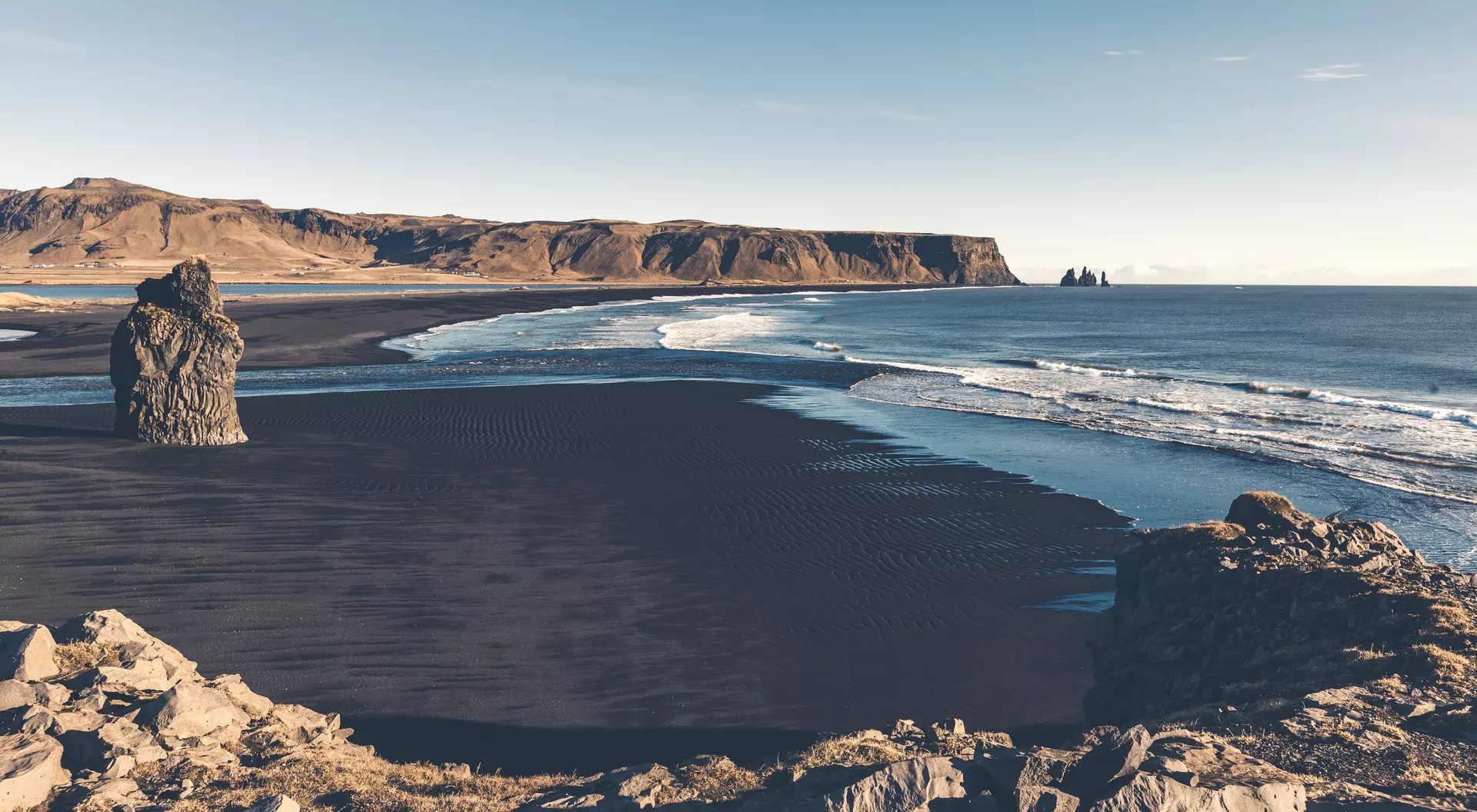 Cape Dyrholaey, Arnardrangur Rock on black sand beach.