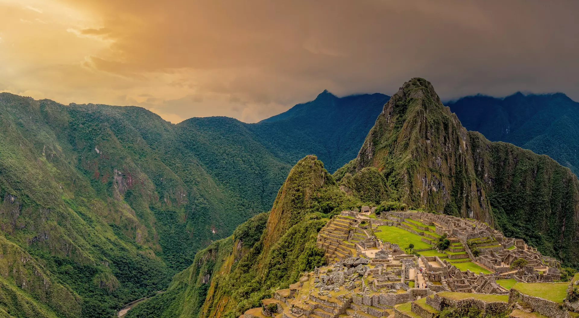 Machu Picchu is a 15th-century Inca citadel located in the Eastern Cordillera of southern Peru on a 2,430-meter (7,970 ft) mountain ridge. It is located in the Machupicchu District within Urubamba Province above the Sacred Valley, which is 80 kilometers (50 mi) northwest of Cusco. The Urubamba River flows past it, cutting through the Cordillera and creating a canyon with a tropical mountain climate. Most recent archaeologists believe that Machu Picchu was constructed as an estate for the Inca emperor Pachac