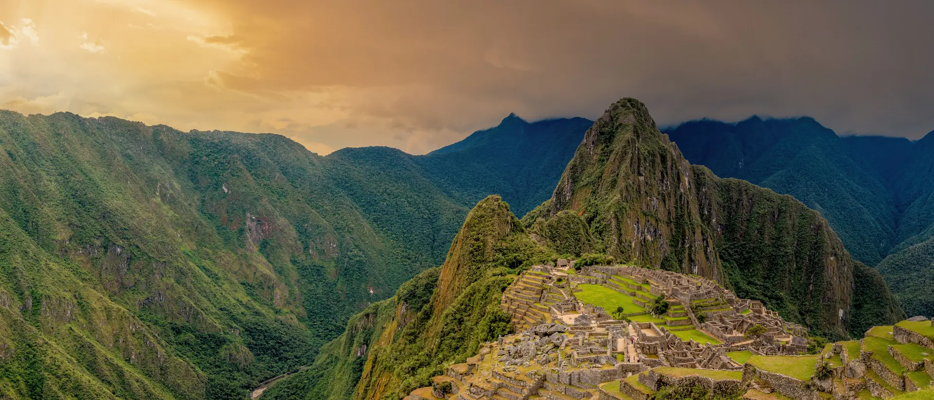 Machu Picchu is a 15th-century Inca citadel located in the Eastern Cordillera of southern Peru on a 2,430-meter (7,970 ft) mountain ridge. It is located in the Machupicchu District within Urubamba Province above the Sacred Valley, which is 80 kilometers (50 mi) northwest of Cusco. The Urubamba River flows past it, cutting through the Cordillera and creating a canyon with a tropical mountain climate. Most recent archaeologists believe that Machu Picchu was constructed as an estate for the Inca emperor Pachac
