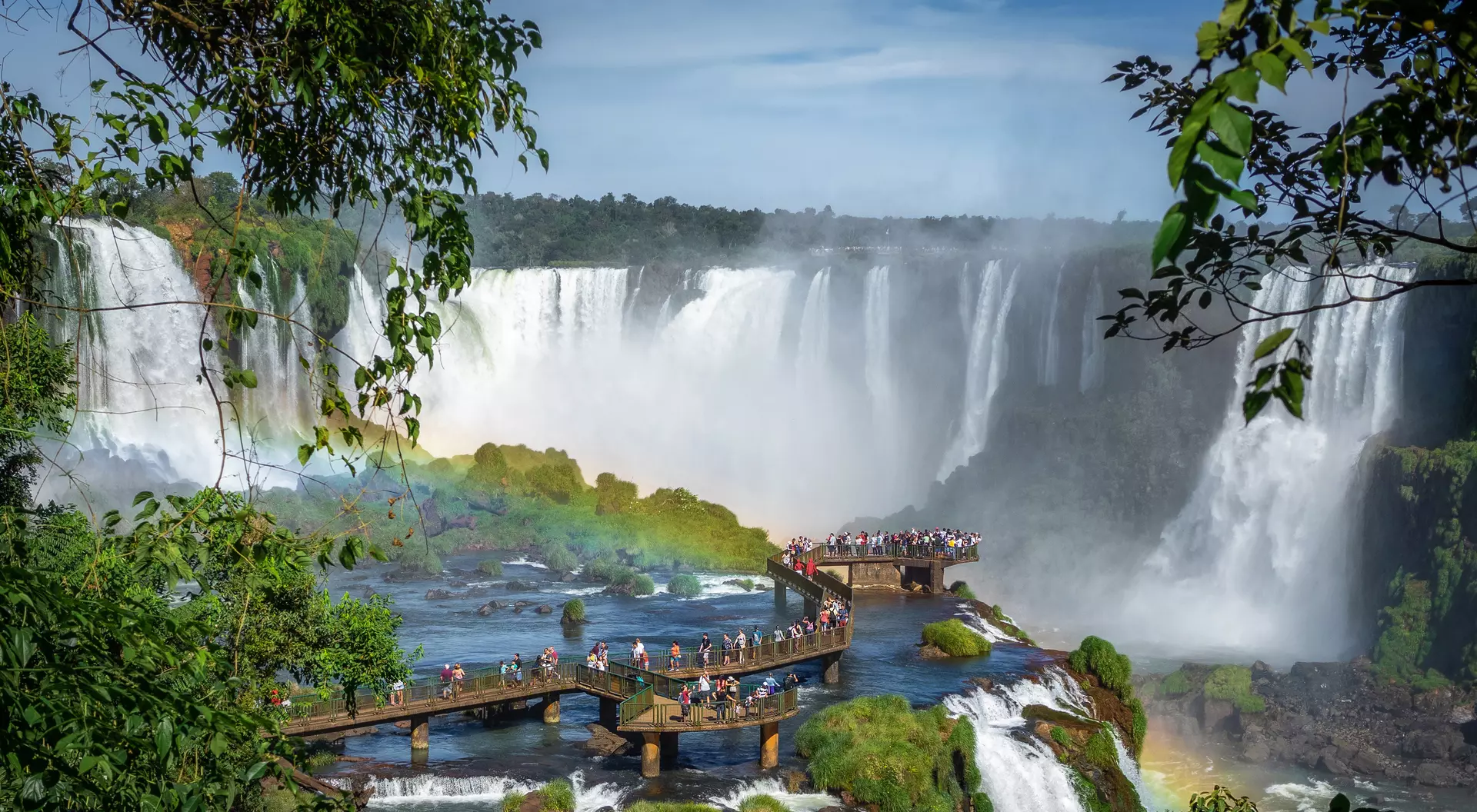 Tourists Exploring Iguazu Falls on the boardwalk of the Brazil side.