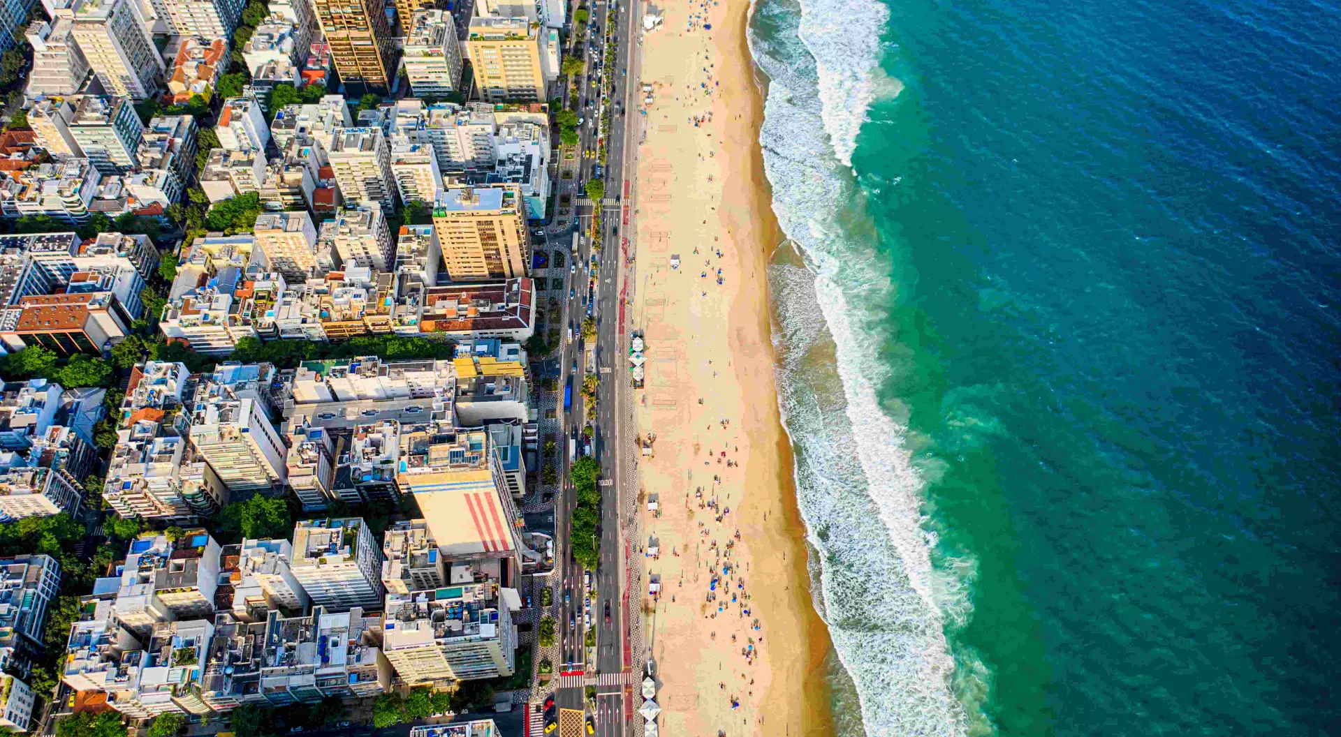Ipanema district, strip of sand with people enjoying the beach and the ocean