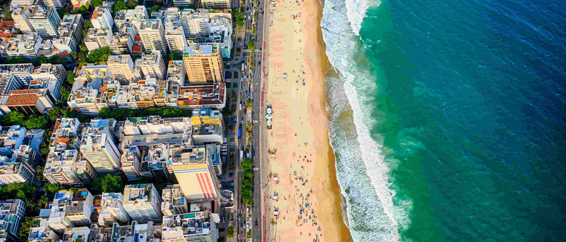 Ipanema district, strip of sand with people enjoying the beach and the ocean