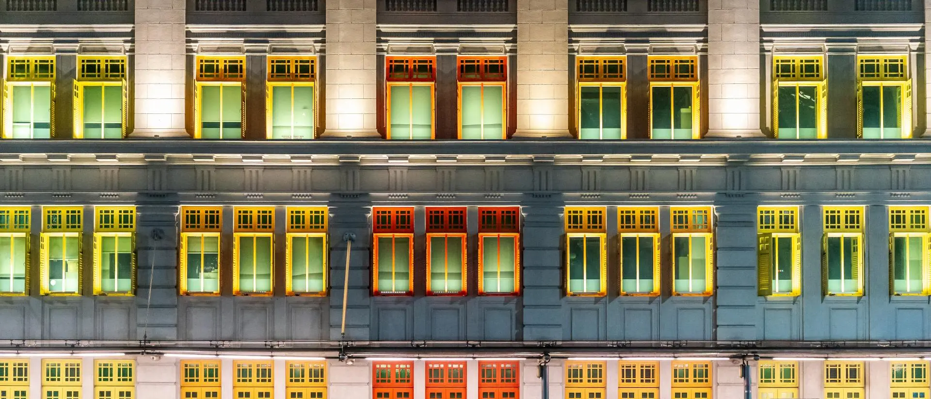 The Old Hill Street Police Station at night, building with colourful windows