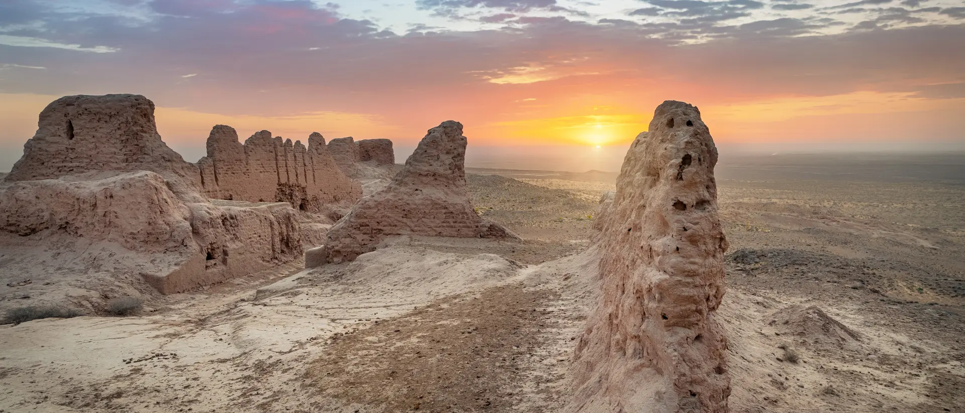 Ruins of ancient Khorezm fortress Ayaz Kala in Kyzylkum desert on sunrise
