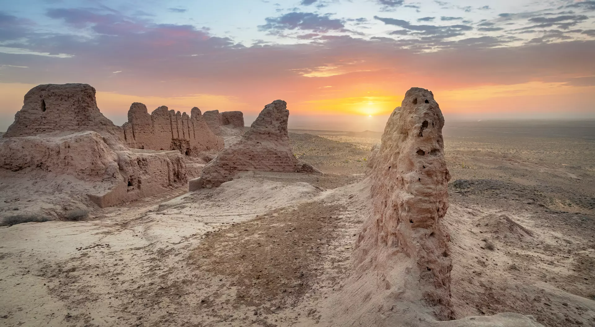 Ruins of ancient Khorezm fortress Ayaz Kala in Kyzylkum desert on sunrise