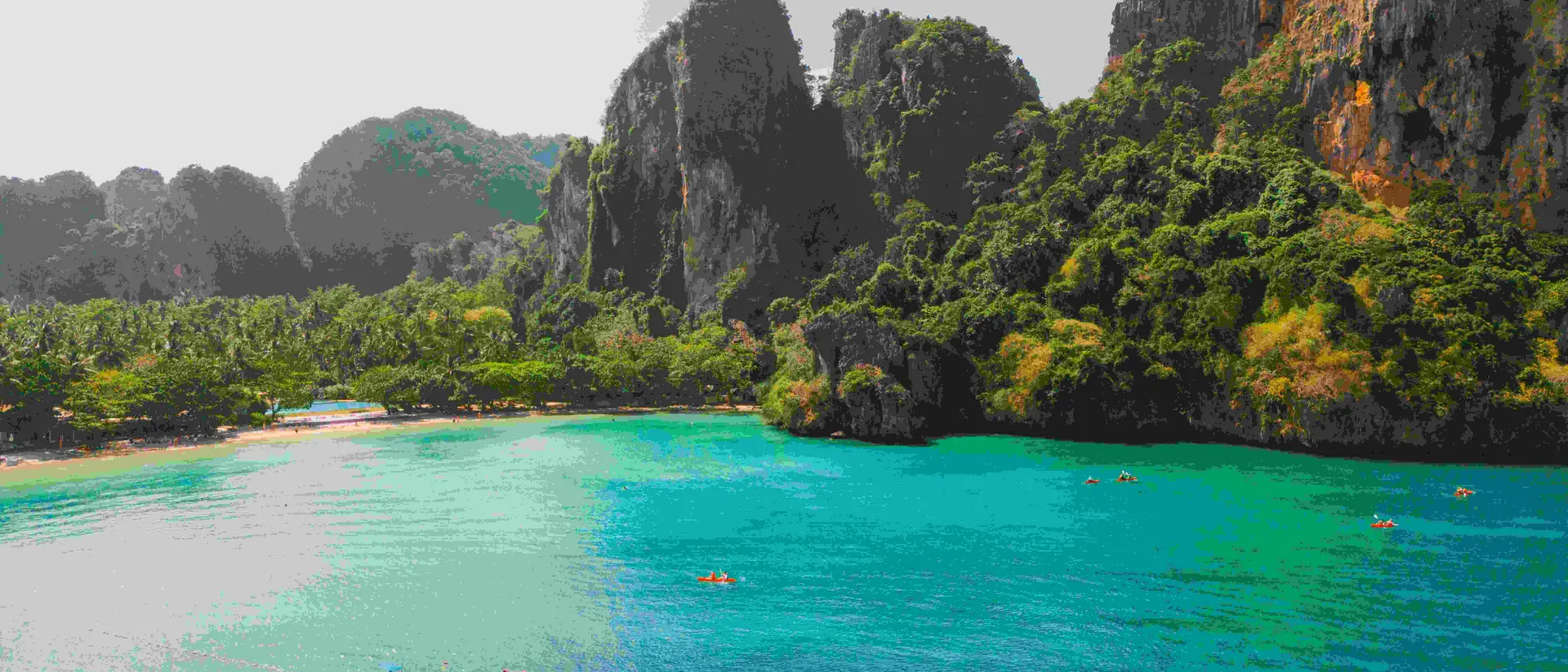 Scenic aerial view of sea kayaking near idyllic Railey beach in Thailand