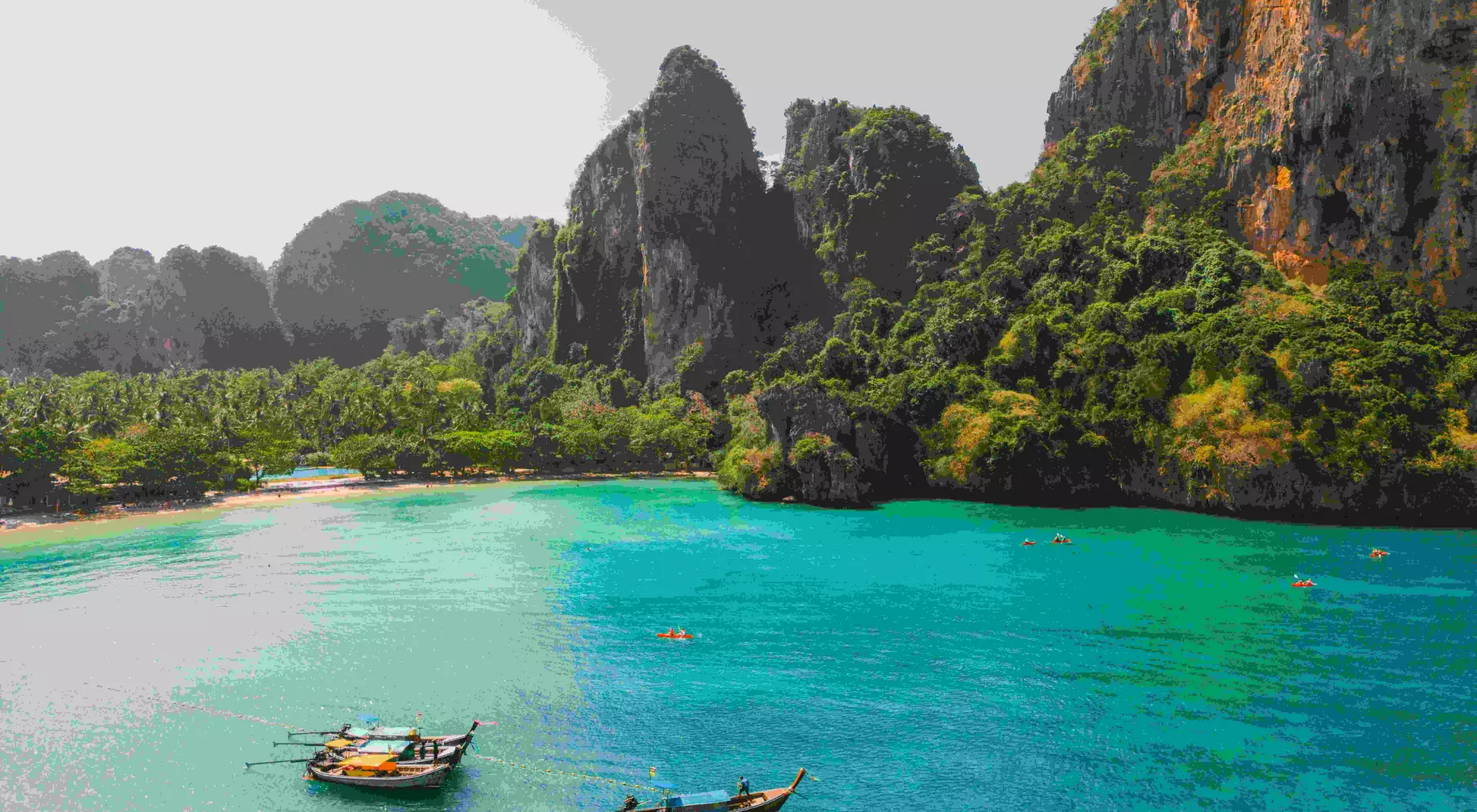 Scenic aerial view of sea kayaking near idyllic Railey beach in Thailand