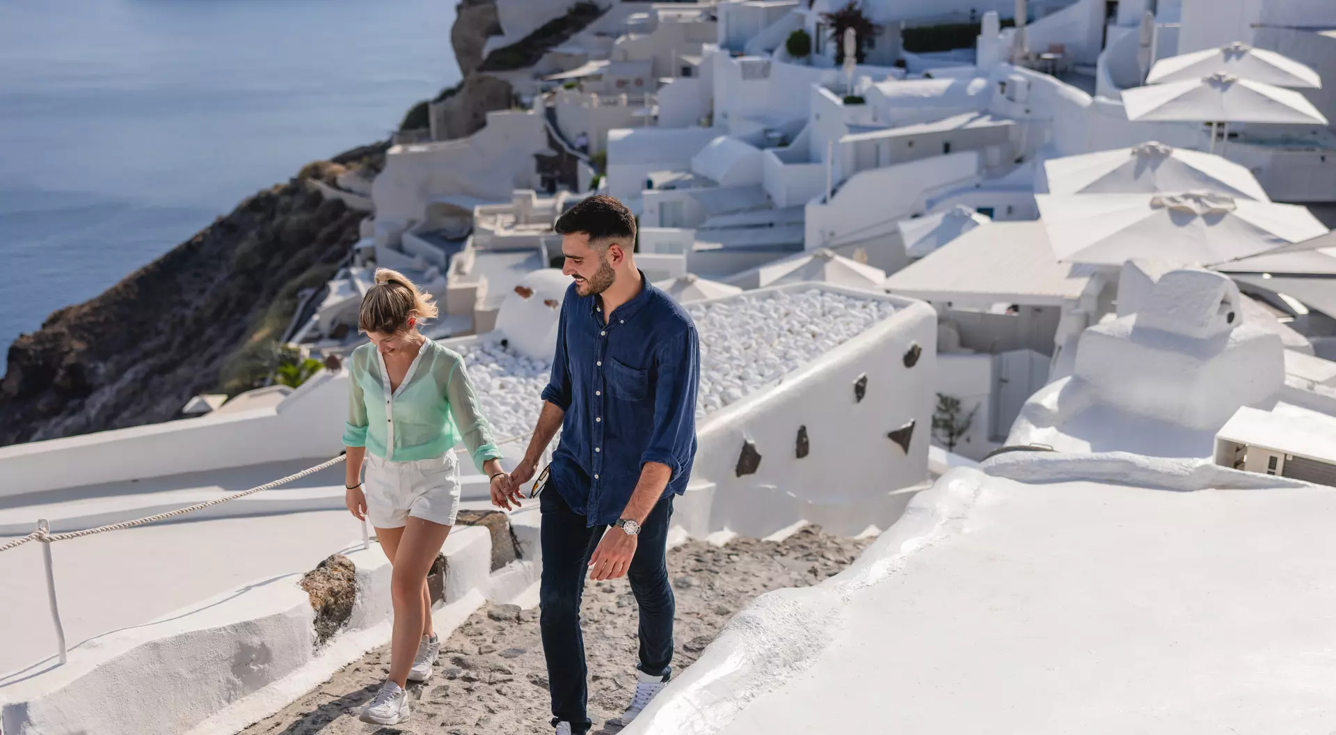 Couple walking around the beautiful village of Oia