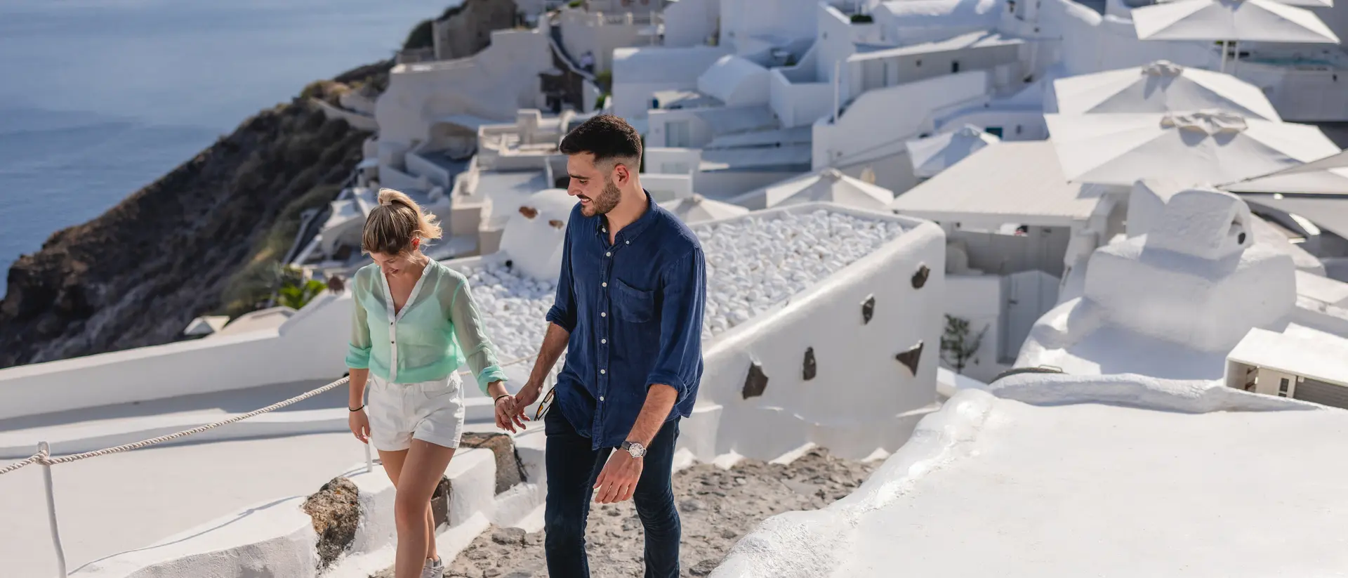 Couple walking around the beautiful village of Oia