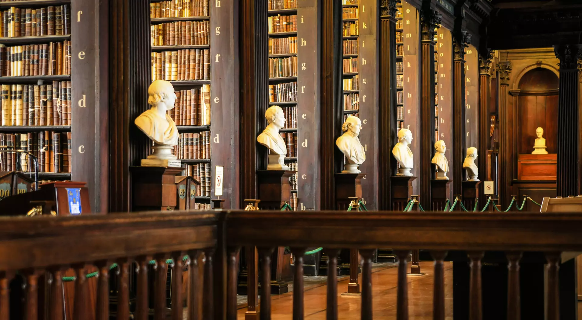 Thousands of books on shelves inside the Trinity College Library Dublin, Part of the University of Dublin