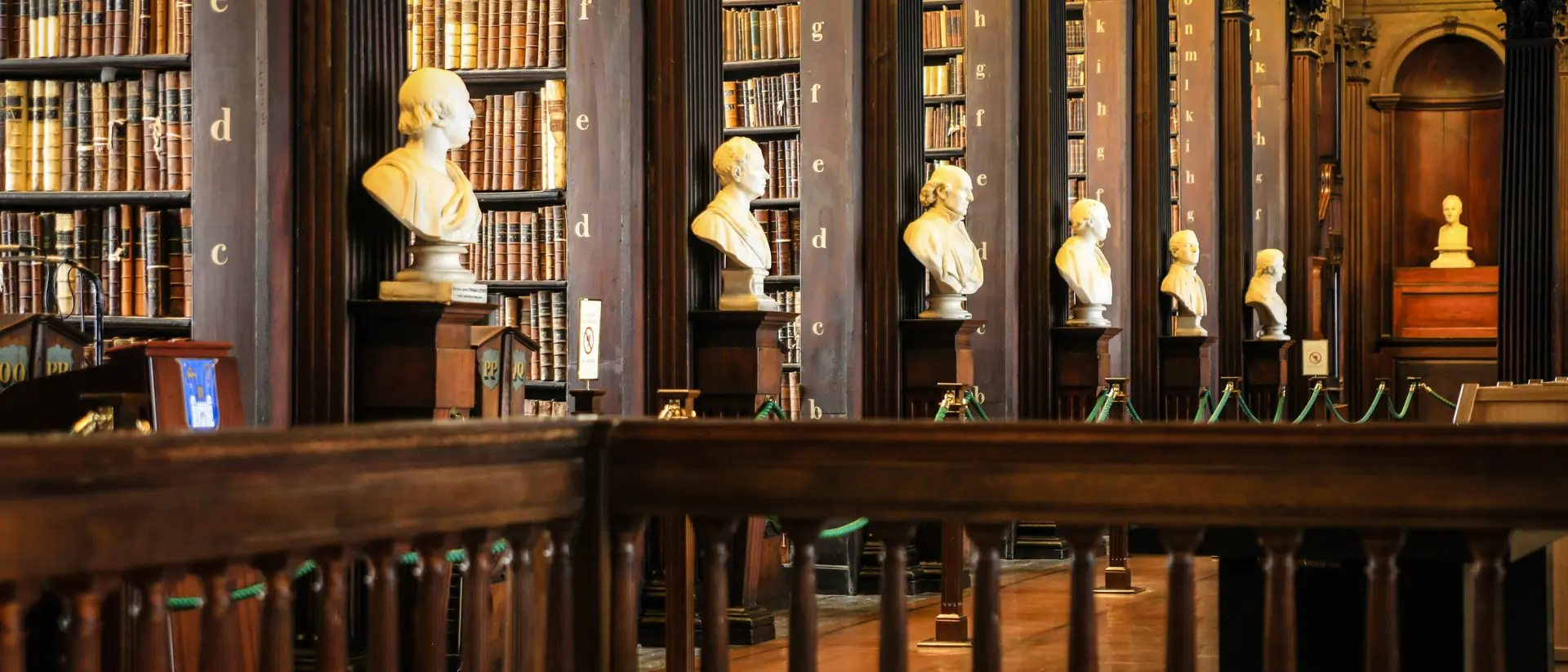 Thousands of books on shelves inside the Trinity College Library Dublin, Part of the University of Dublin