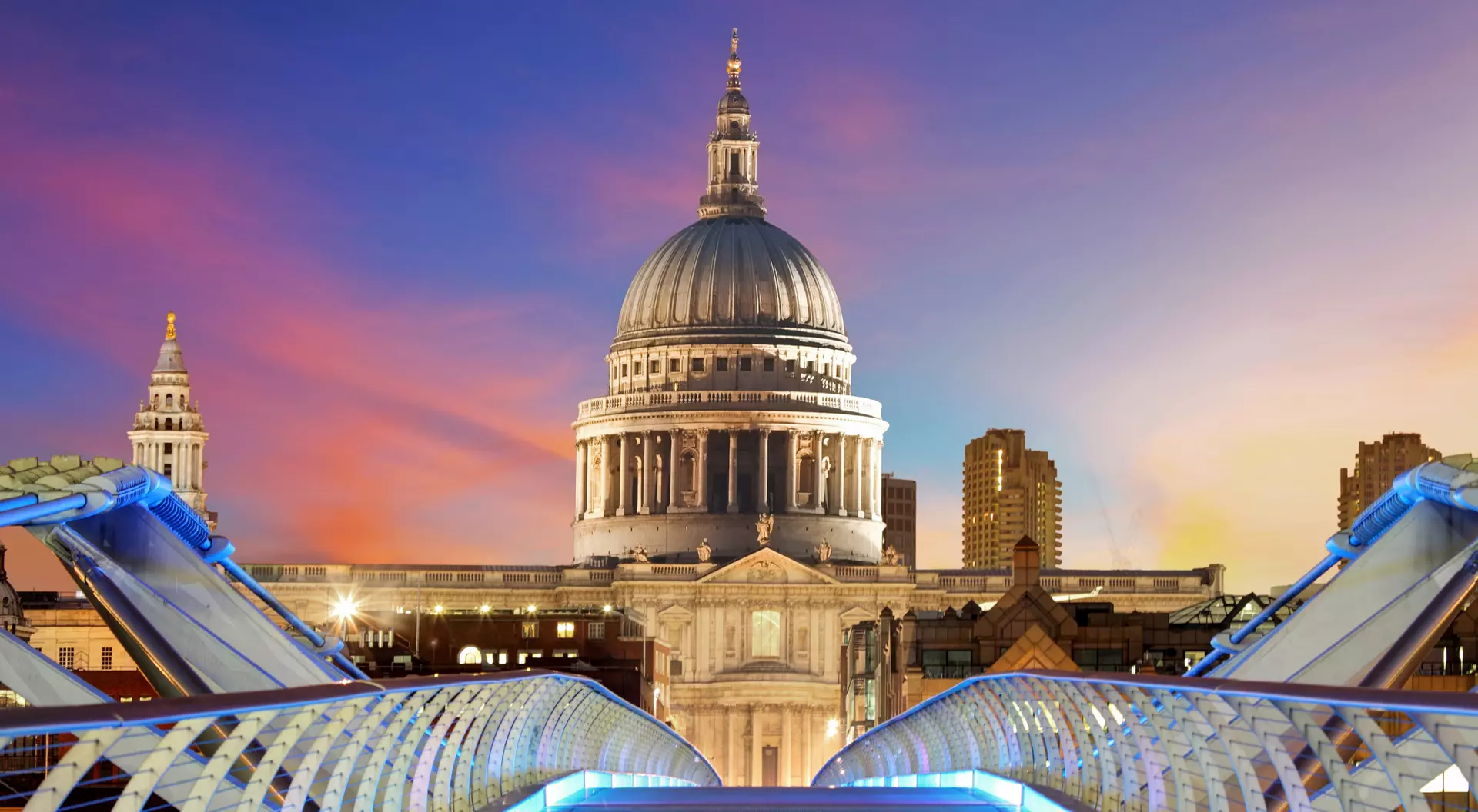 Millennium Bridge leads to Saint Paul's Cathedral in central London at night.