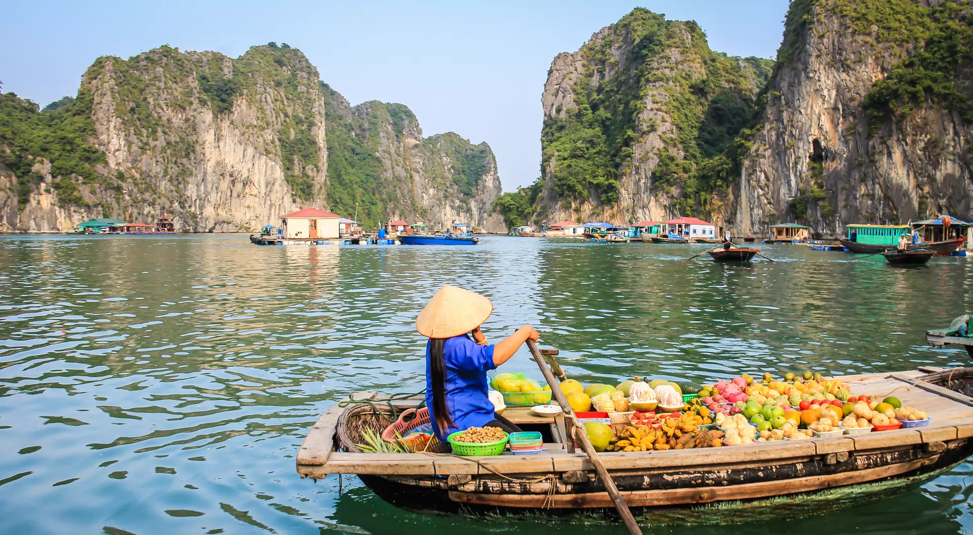 Fruit seller in a boat, Halong Bay Vietnam