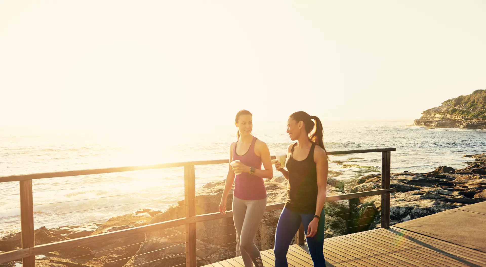 Women walking along the coast