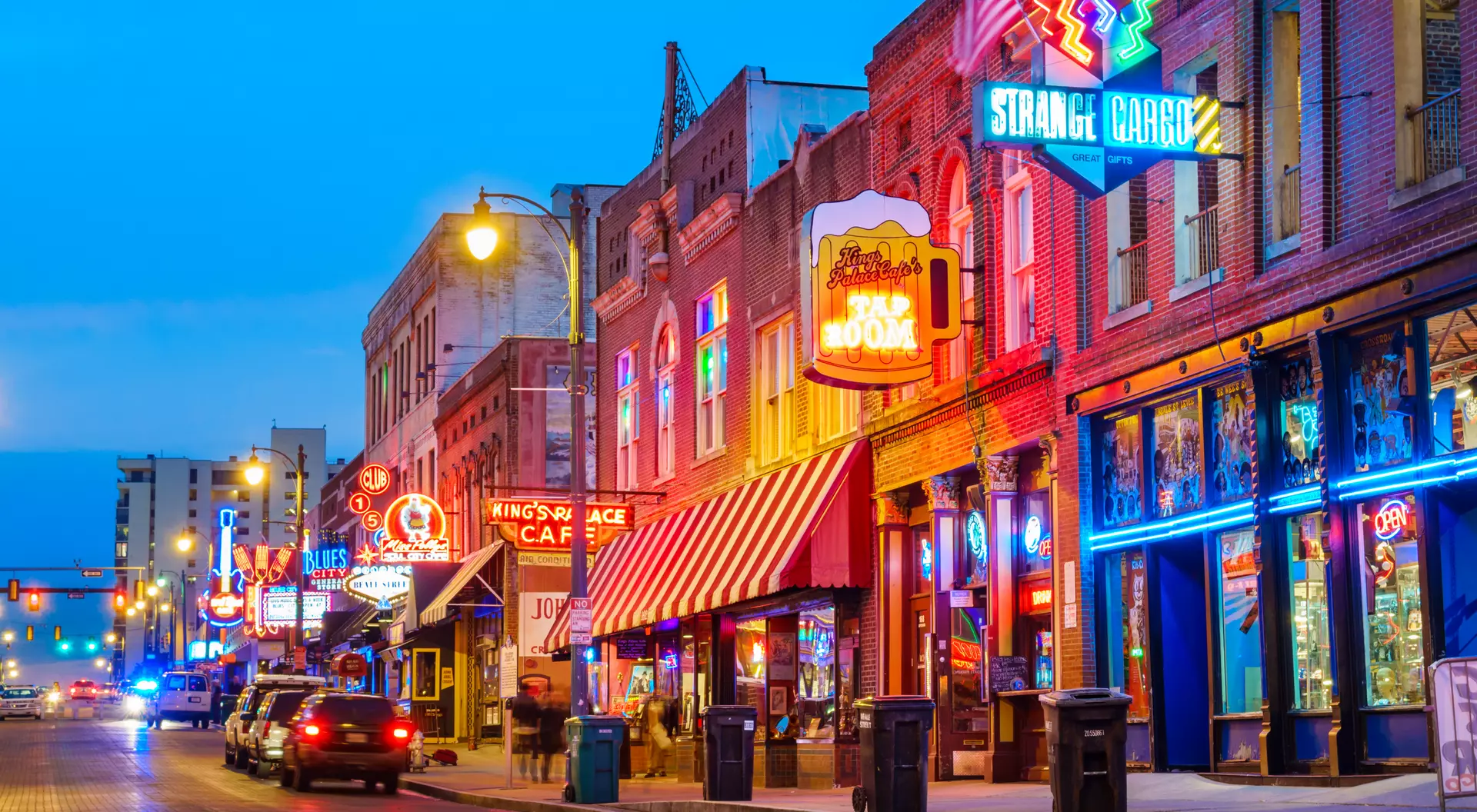 Photo of colorful cafe bars at the iconic Beale Street music and entertainment district of downtown Memphis, Tennessee, USA, illuminated at night.