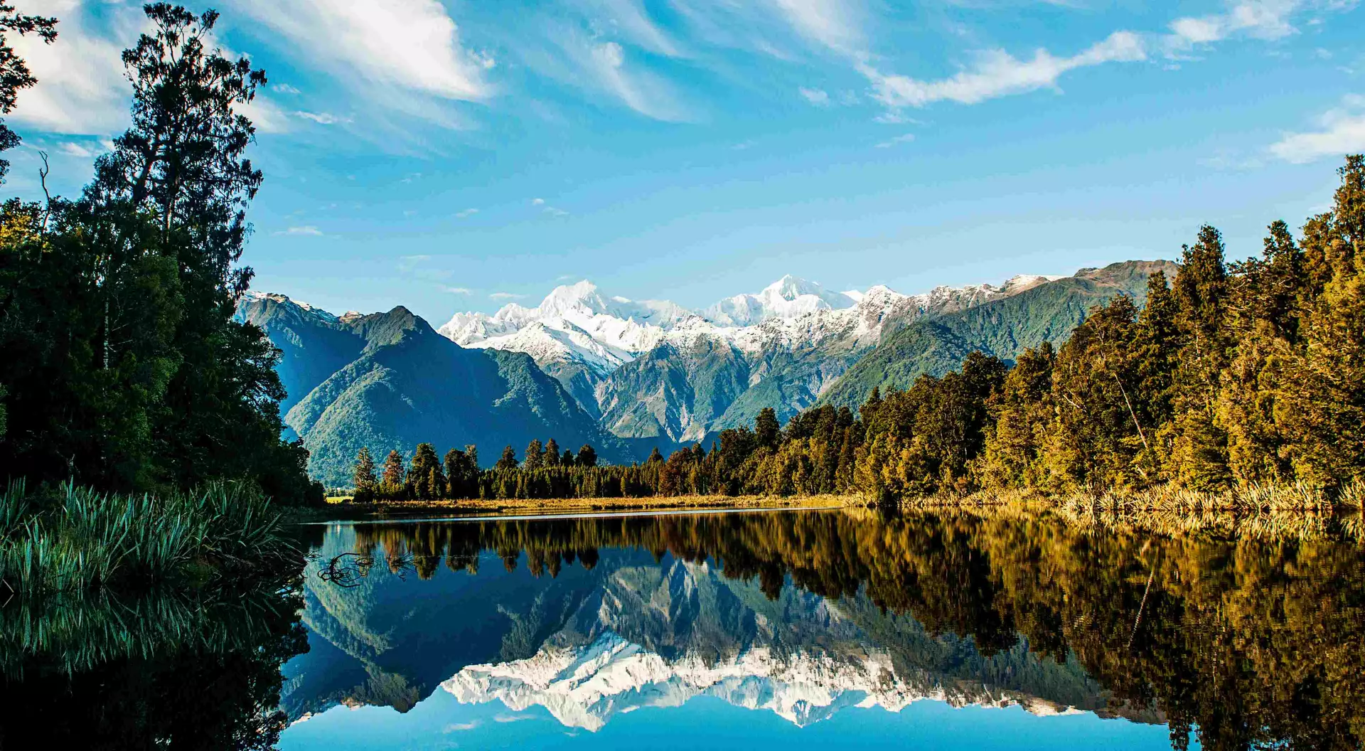 Reflections of Mount Cook and Mount Tasman in Lake Matheson, Fox Glacier New Zealand.