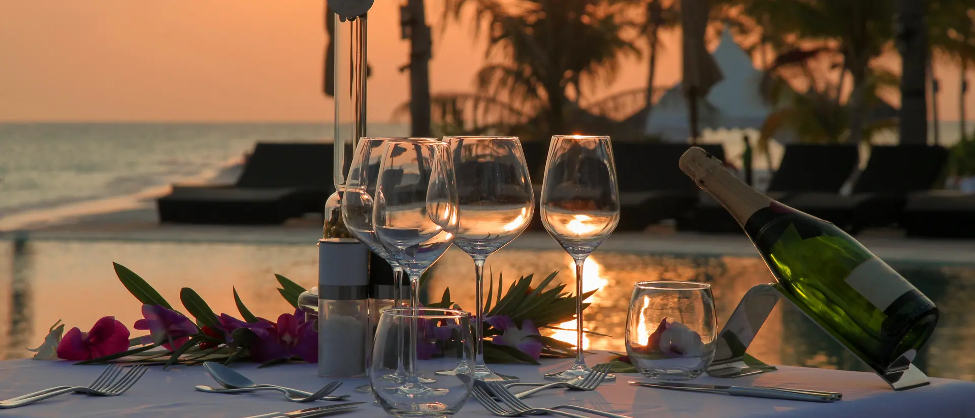 Beach Dinner by the Infinity Pool in Sunset Scenery.