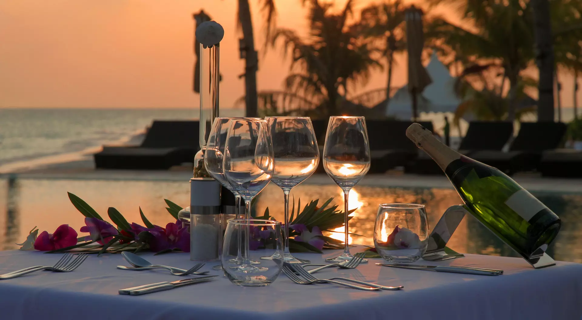 Beach Dinner by the Infinity Pool in Sunset Scenery.