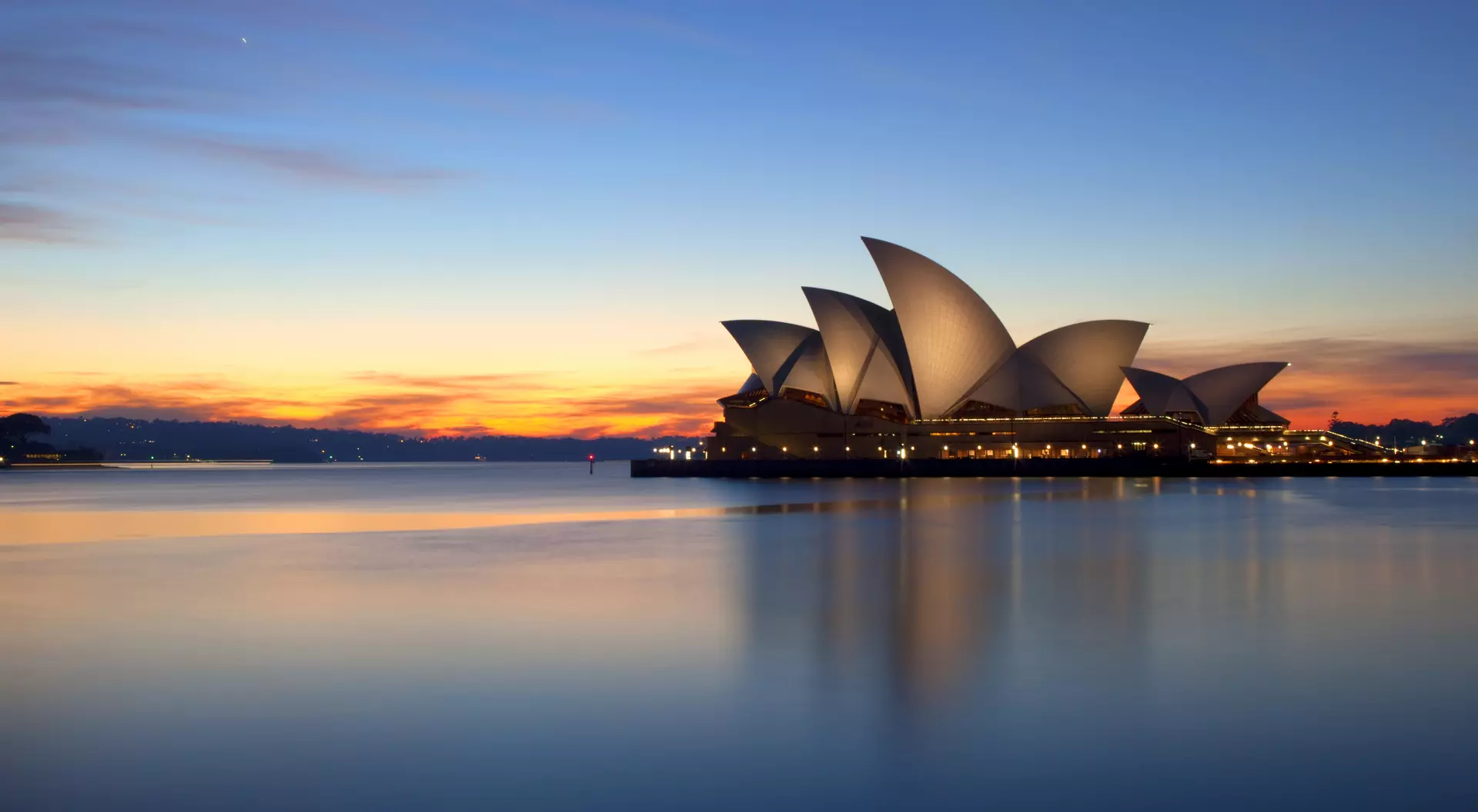 Pre-dawn sunlight lights up the sky over Sydney, Australia.