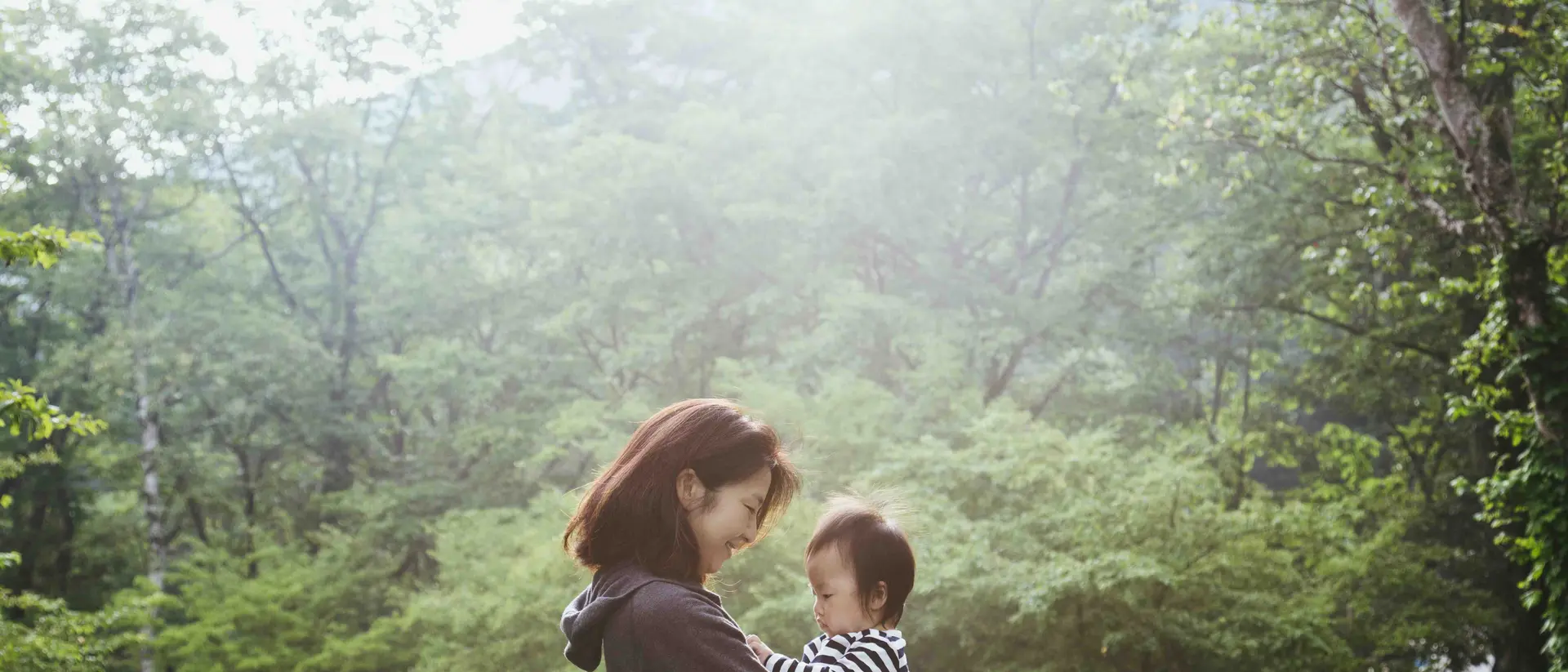 Mother carrying her baby girl in the mountain.