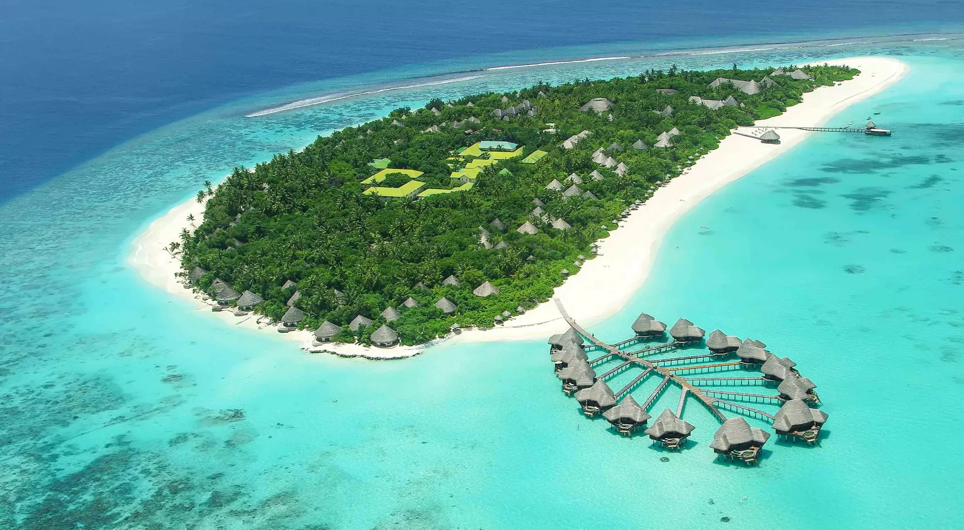 aerial view of overwater bungalows and white-sand beach island
