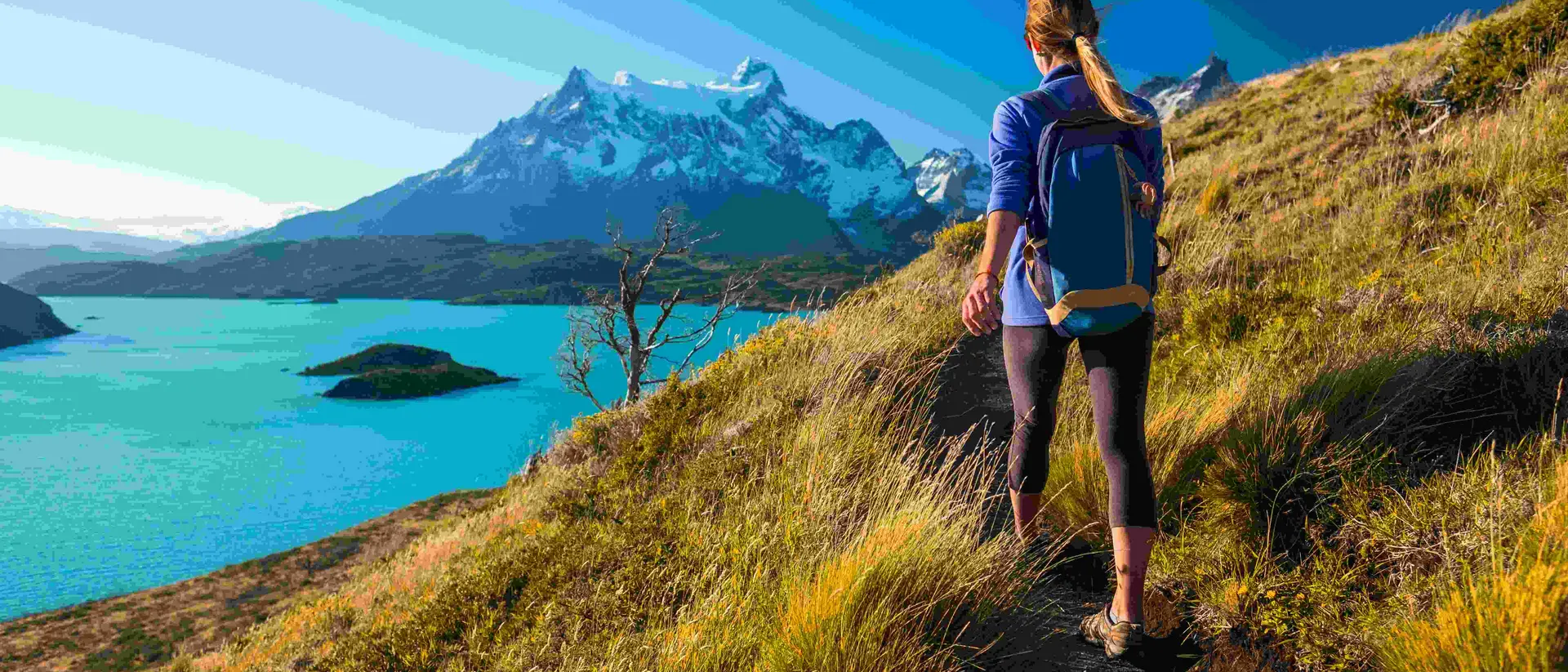 Woman hiker walks on the trail in the Torres del Paine National Park. Chile