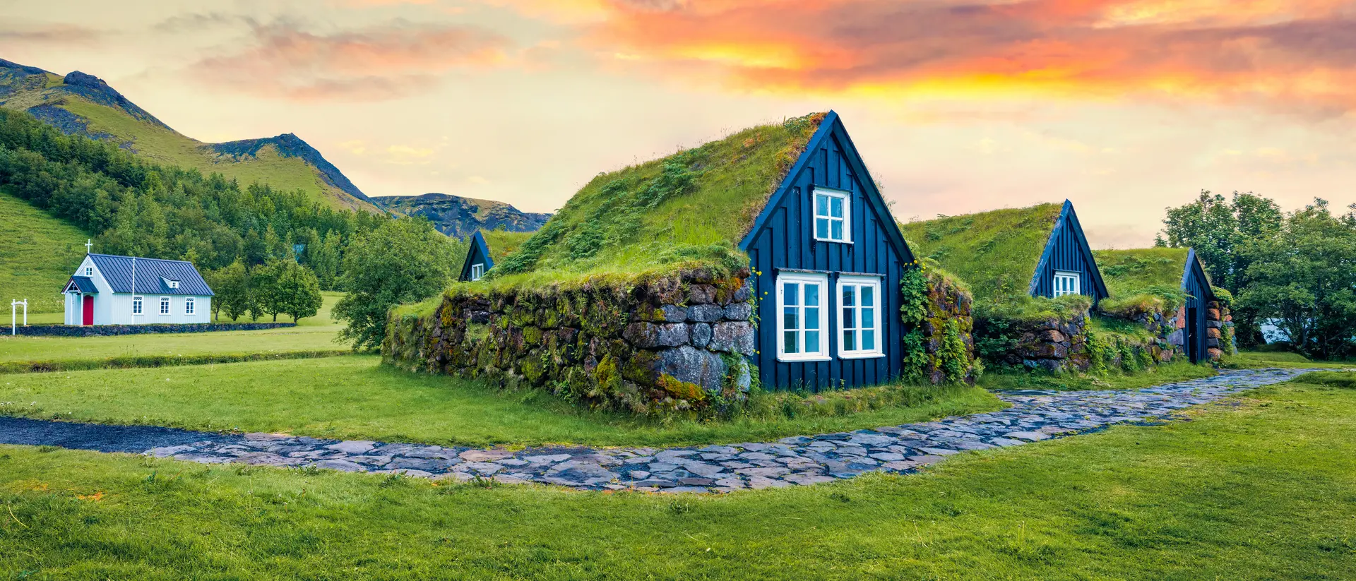 Typical view of turf-top houses in Icelandic countryside.