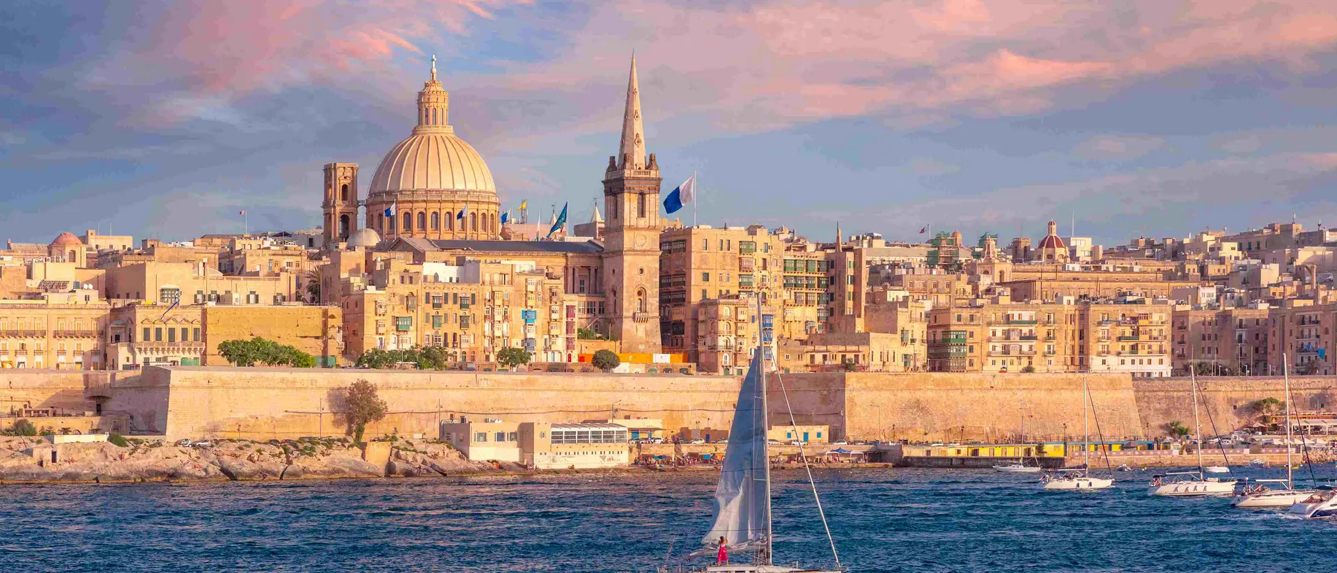 The old town of Valletta with churches of Our Lady of Mount Carmel and St. Paul's Anglican Pro-Cathedral at sunset, Valletta, Malta.