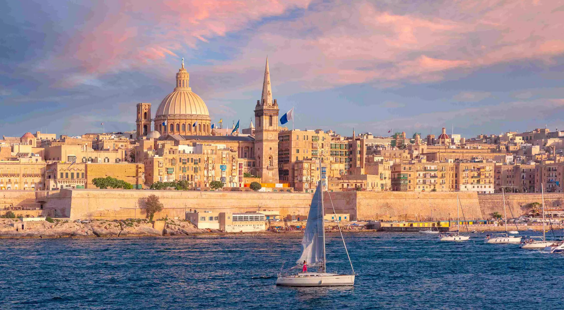 The old town of Valletta with churches of Our Lady of Mount Carmel and St. Paul's Anglican Pro-Cathedral at sunset, Valletta, Malta.