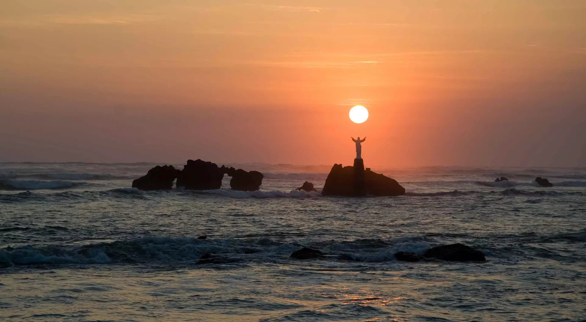 The sun sets over the ocean in El Salvador.