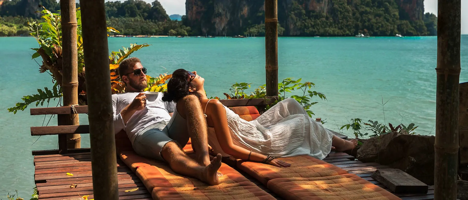 couple lounging alongside the blue waters of southern Thailand