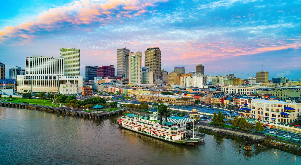Skyline of city along the Mississippi river, steamboat in foreground