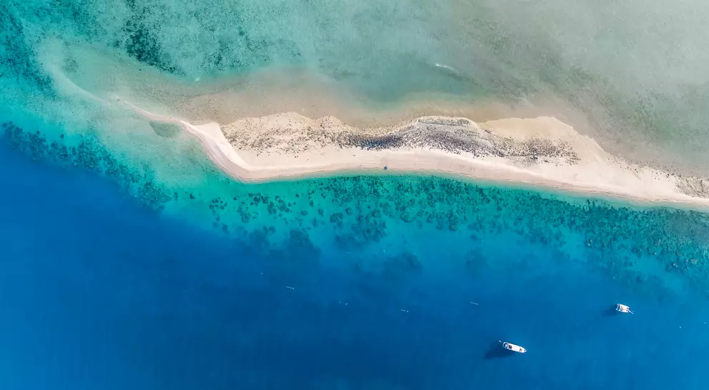 High angle aerial drone view of the sandbar and blue waters