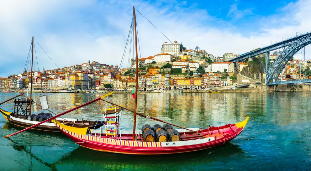 Panorama of beautiful Porto with traditional boats on the river