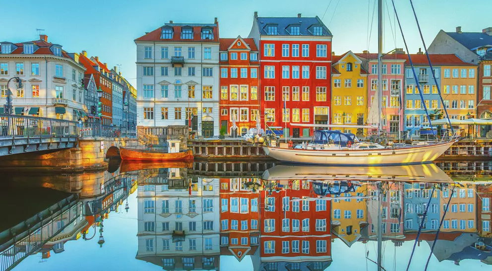 View of clear waters reflecting the buildings of Nyhavn along the canals of Copenhagen, Denmark