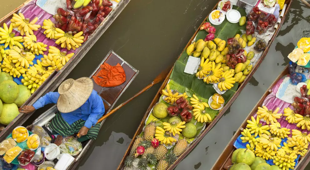 Floating market, boats filled with fruits and vegetables, in Bangkok, Thailand 