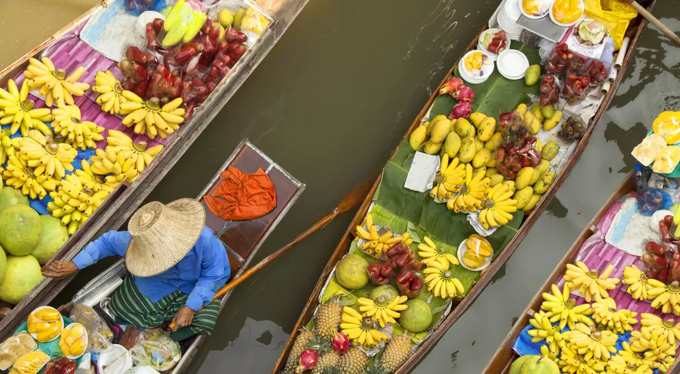 Floating market, boats filled with fruits and vegetables, in Bangkok, Thailand 
