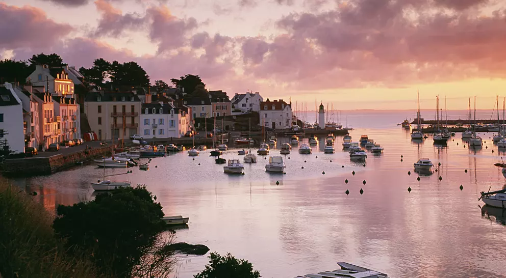 Harbour with boats in the water at sunset