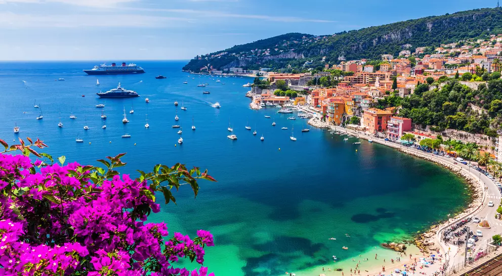 Aerial view of the vibrant town and beach with boats in the water