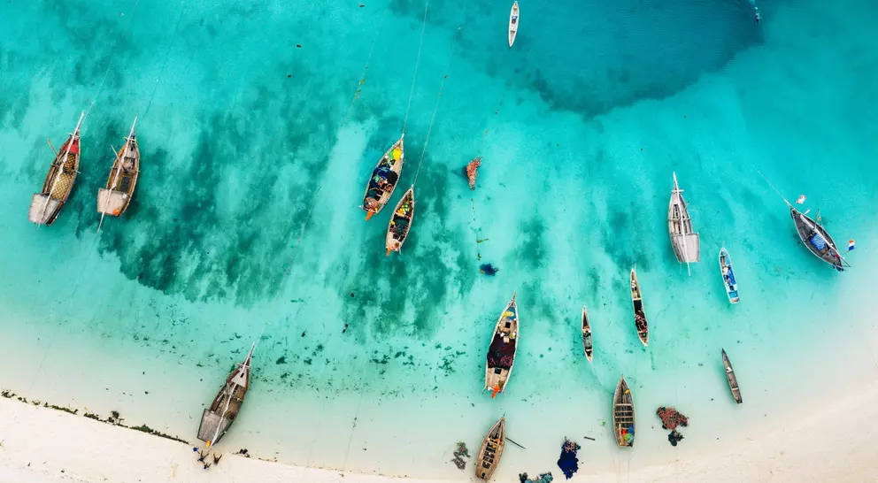 Aerial photos of boats and stunning blue waters of beach