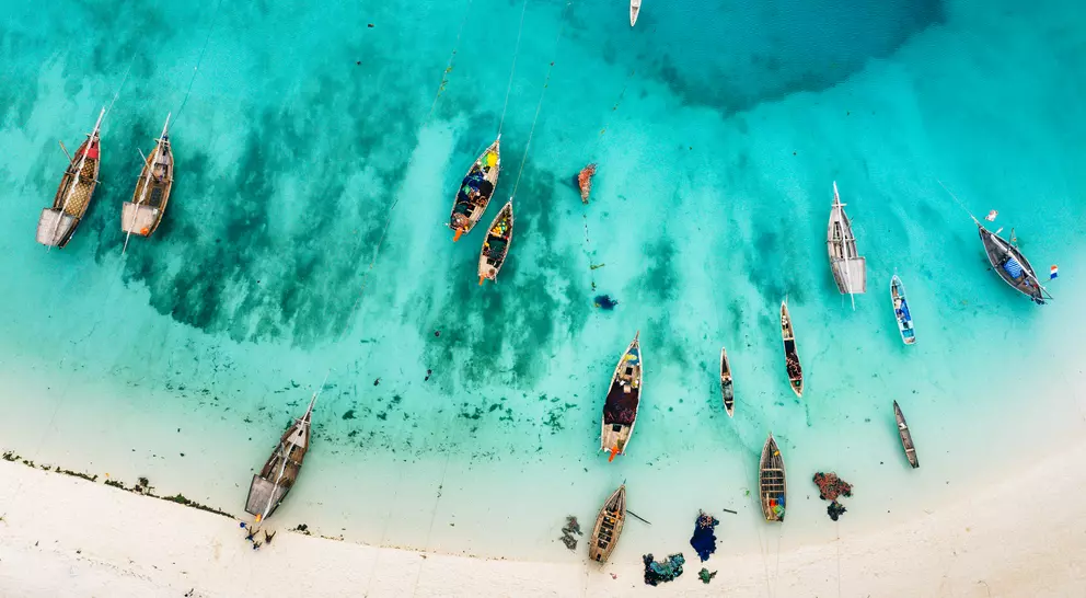 Aerial photos of boats and stunning blue waters of beach