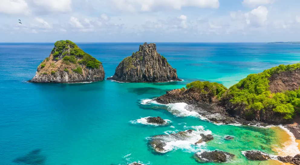 Aerial view of tropical island coastline with beautiful waters
